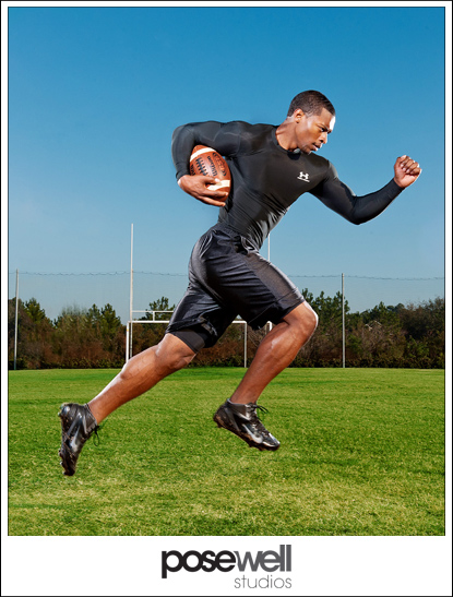 Photograph of athlete running with a football