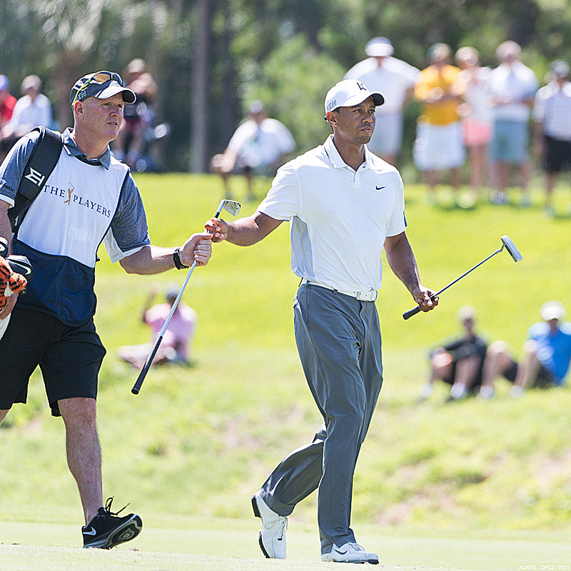 Tiger Woods at The PLAYERS 2015 handing his club to his caddie - photo by Agnes Lopez